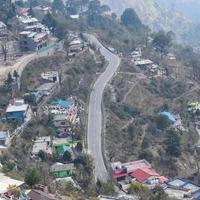 Aerial top view of traffic vehicles driving at mountains roads at Nainital, Uttarakhand, India, View from the top side of mountain for movement of traffic vehicles photo