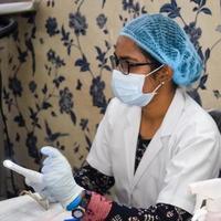 Delhi, India - November 19, 2022 - Basic routine health check-up camp has been organized by max hospital specialized doctors, Patient at annual health check-up, Doctor doing health check-up to patient photo