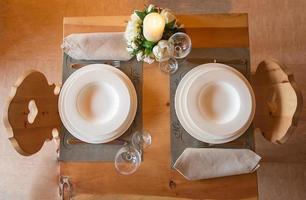 Table set in mountain chalet for two people photo