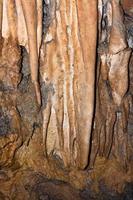 Stalactites in limestone caves visited by speleologists photo