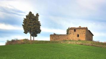 Hermitage crumbling in the meadow in Tuscany Italy photo