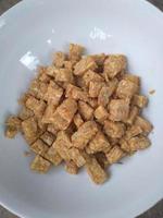 Famous Javanese cuisine food , Tempe or Tempeh made of fermentation process that binds soybeans into a cake form, sliced and fried. Famous in Indonesia and Malaysia photo