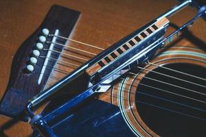 Harmonica holder and folk guitar photo