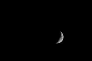 Half moon illuminated from the west in the black sky photo