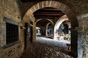 The arcades of the Cornello dei Tasso. Ancient village of the brembana valley Bergamo Italy photo