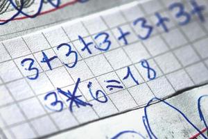 Mathematical operations at school written by a child photo