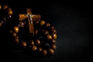 Wreath of the holy wooden rosary on a black background photo