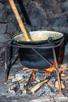 Polenta pot on the fire photo