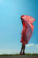 woman covered by red veil photo