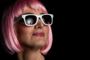 Portrait of girl with studio lights on umbrella reflecting in glasses photo