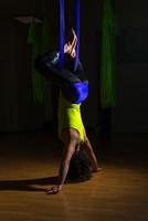 chica guapa practica posición de yoga antigravedad en el gimnasio en un blu foto