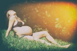 Vintage pregnant woman in the meadow photo