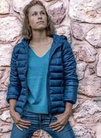 Young girl with thumbs in the pockets of jeans photo