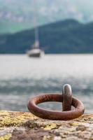 Mooring hook in the lake of mountain with the boat in the background photo