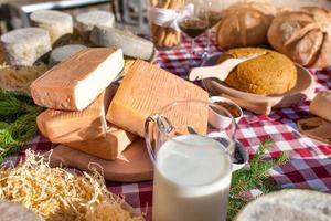 Milk and cheese with food on a table outside a farmhouse in the Italian Alps photo