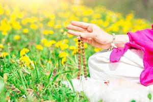 Use of Mala with mantras during a yoga practice photo