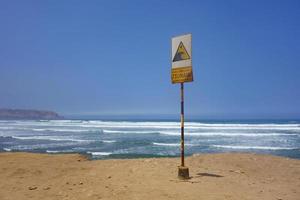 Warning sign of Tsunami danger over ocean photo