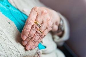 Hand of elderly woman with rings photo