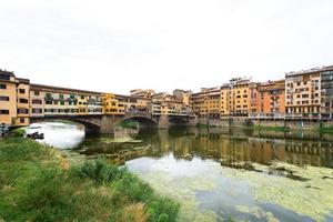 Florence view of the Arno River with the old bridge ponte vecchio photo