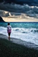 Girl walking by the sea photo