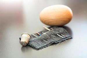 Sewing needles with thimble and egg for mitt photo