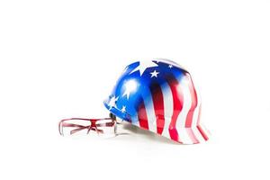 Safety items for construction sites. American helmet with color flag and safety glasses. photo