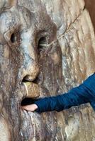 Hand entering the famous mouth of truth in the church of Santa Maria in cosmedin in Rome -italy photo