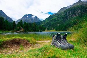 Hiking boots resting on the grass photo