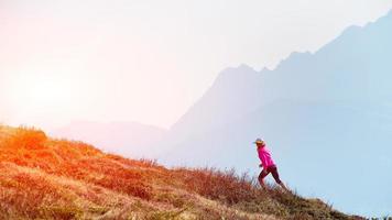 Female athlete ago in the mountains training photo