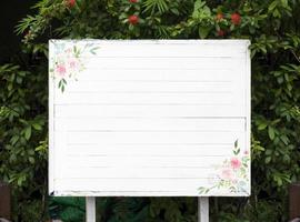 Outdoor white sign with green leaf natural background photo