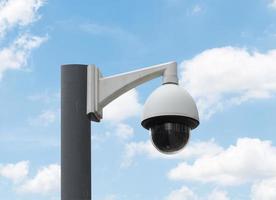 Outdoor white CCTV on pole with blue sky background and copy space photo