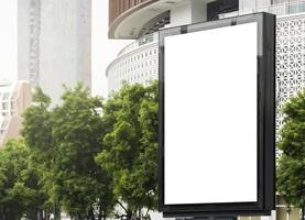 Outdoor pole billboard with mock up white screen on city view background and clipping path photo