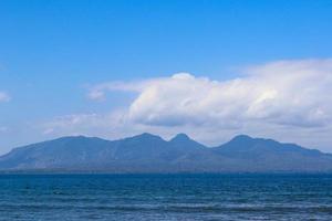 beautiful view of Cacalan Banyuwangi beach with mountains in the background photo