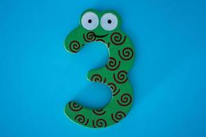 The green number three on a blue background. photo