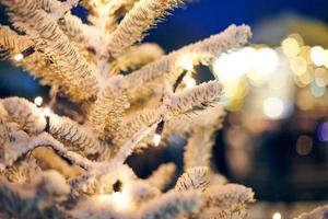 Christmas tree with yellow garlands lights and bokeh copy space with sparkled bokeh, Christmas time photo