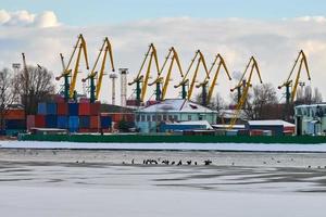 Harbor cranes, container ship terminal, cargo container yard photo