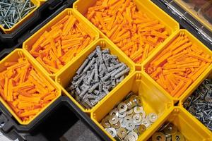 Storage case with screws, nuts, bolts, nails and other small tools for handyman, close up photo