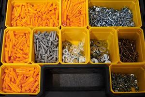 Storage case with screws, nuts, bolts, nails and other small tools for repairer, top view photo