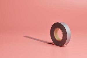 Electrical tape roll, copy space. Minor repairs in house concept. Minimal pink background. photo