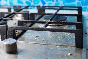 Dirty gas stove with food leftovers and crumbs photo