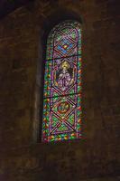 Photo of a colorful church window illuminated by incoming daylight