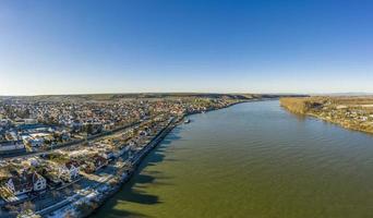 Drone image of wine village Nierstein on the Rhine in blue sky and sunshine with snow covered slopes photo