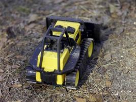 A toy bulldozer in the dirt photo