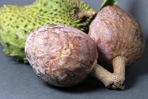 Fresh Custard apple or Bullocks heart fruit isolated on black background photo