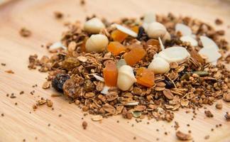 Closed up and blur breakfast healthy food, granola, musli, Organic oat, super food with honey, dried fruits and nuts on wooden plate photo