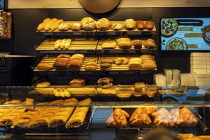 Fresh warm bread on the counter of the store, bakery products trade, modern bakery photo