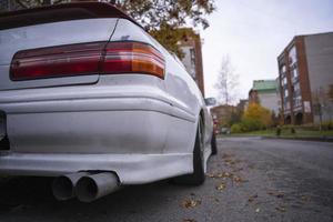 An old classic Japanese car in an autumn urban landscape, popular sedan made in Japan parking on city urban street photo