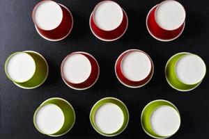 Creative minimalistic composition, pattern of inverted paper cups on a black background, coffee, ecology concepts photo