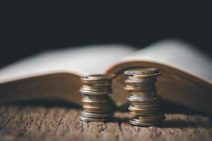 One tenth or tithe is basis on which Bible teaches us to give one tenth of first fruit to God. coins with Holy Bible. Biblical concept of Christian offering, generosity, and giving tithes in church. photo