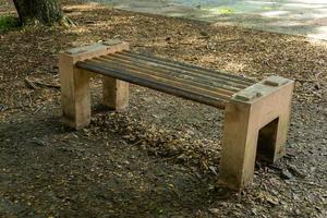 Concrete bench at the city park. Outdoor cement bench. Chair made from cement at the garden photo